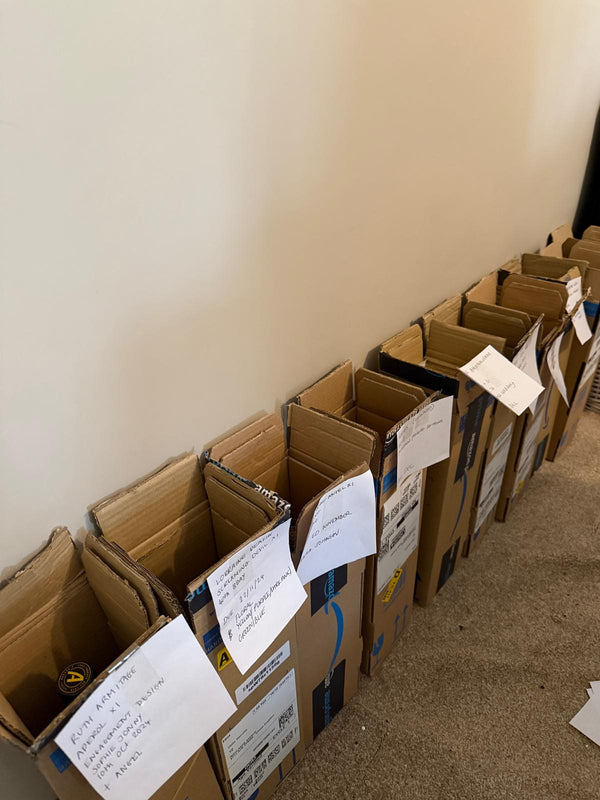 Row of cardboard boxes with labels - bottle and brush orders